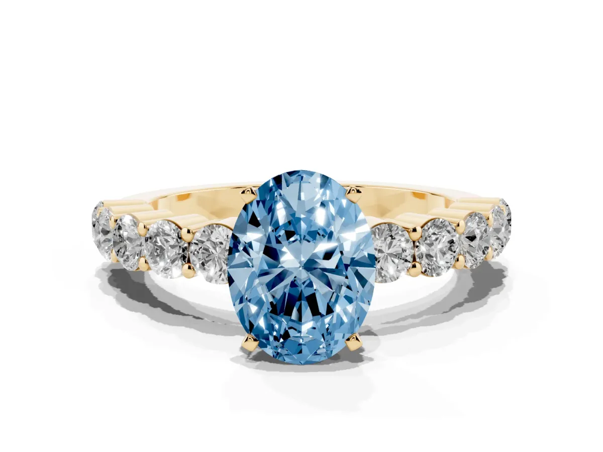 Fancy Blue Oval Cut Diamond Solitaire Ring with Shared Prong Round Side Stones Yellow gold