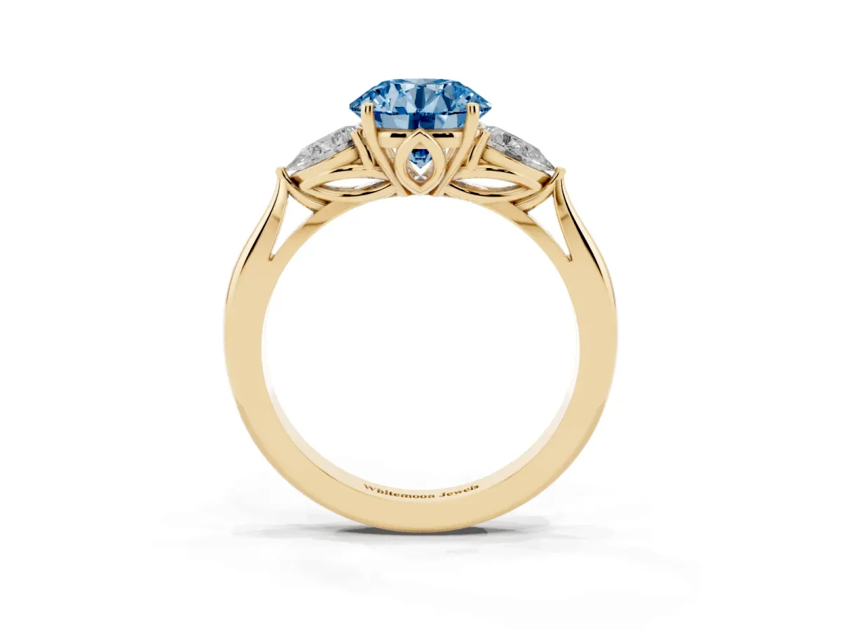 Fancy Blue Three-Stone Round Cut Diamond Ring with Pear Side Stones in Four-Prong Setting Yellow gold