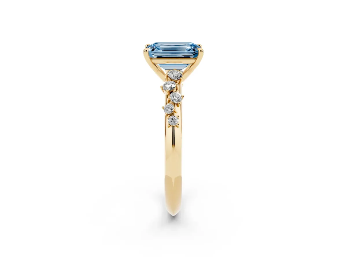 Fancy Blue Emerald Cut Diamond Cluster Side Stone Solitaire Ring with Prong Setting Yellow gold