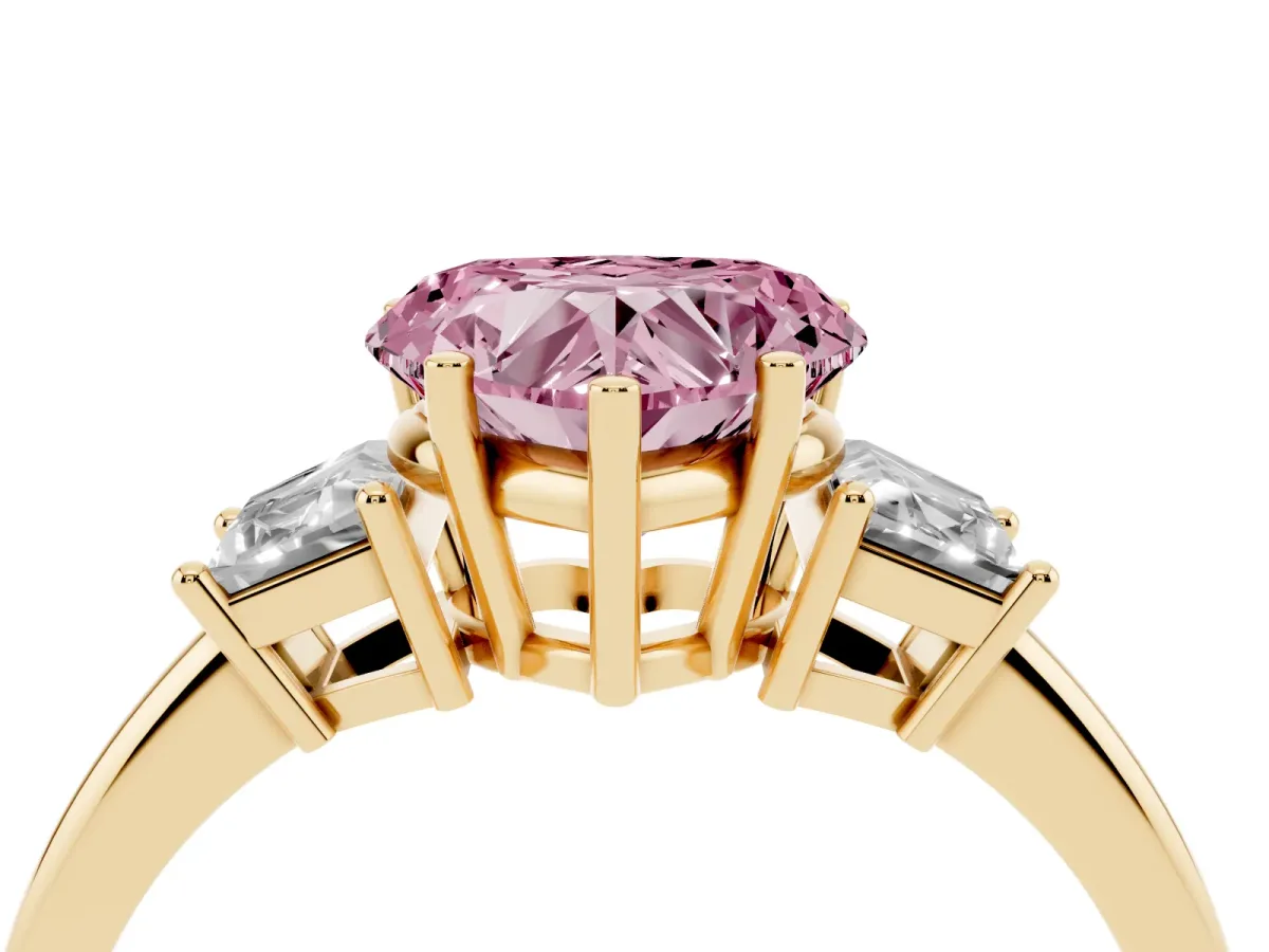 Fancy Pink Heart Cut Diamond Three-Stone Ring with Trapezoid Side Stones and Prong Setting Yellow gold