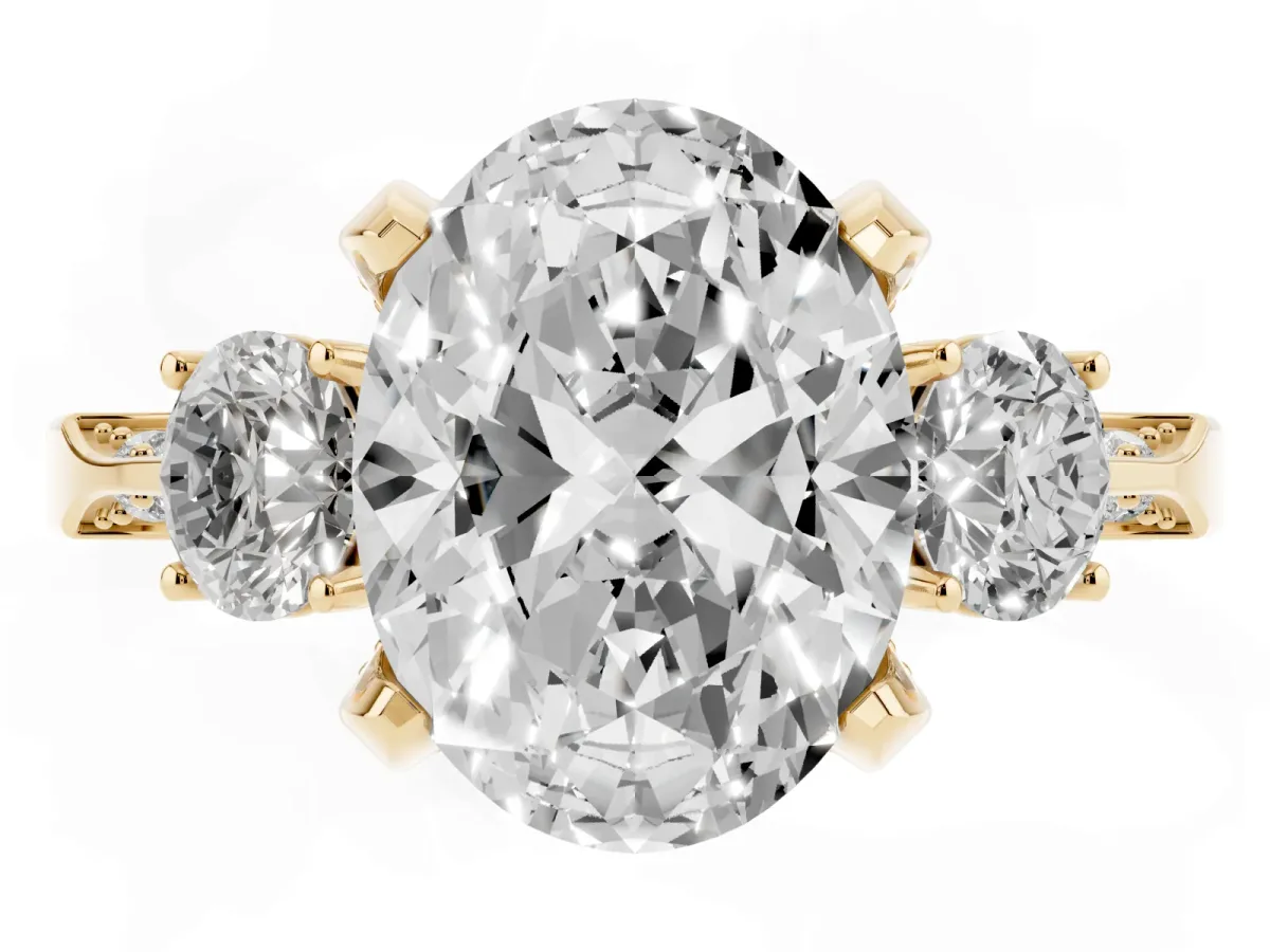 Oval Cut Brilliant Three-Stone Diamond Ring with Pavé Band and Four-Prong Setting Yellow gold