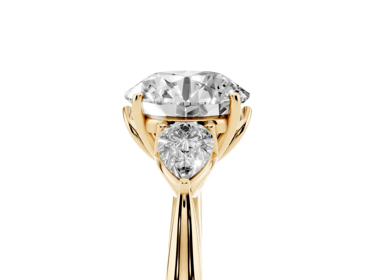 Round Cut Diamond Three-Stone Ring with Pear Side Stones and Prong Setting Yellow gold
