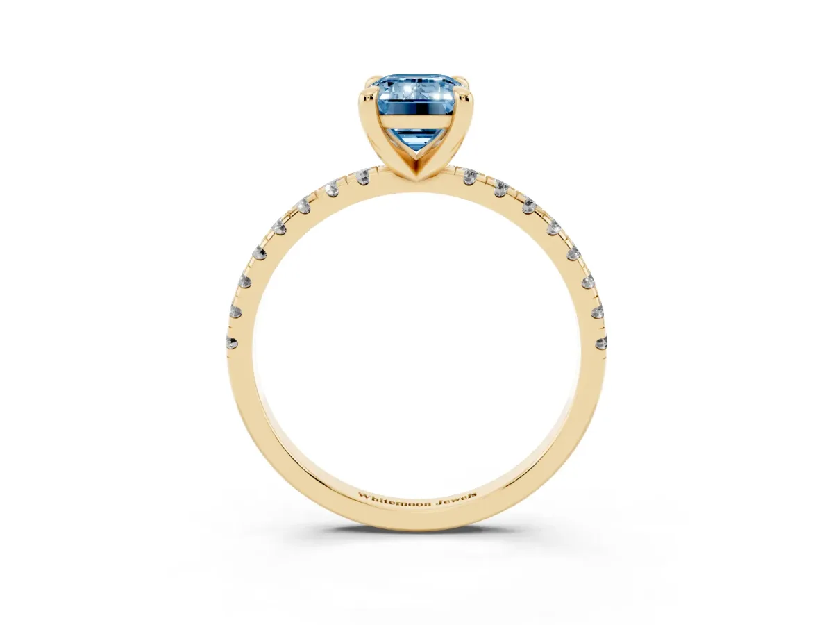 Fancy Blue Emerald Cut Diamond Brilliant Solitaire Ring with Pavé Band and Four-Prong Setting Yellow gold