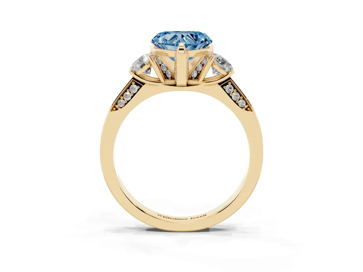 Fancy Blue Heart Cut Brilliant Three-Stone Diamond Ring with Pavé Band and Four-Prong Setting Yellow gold