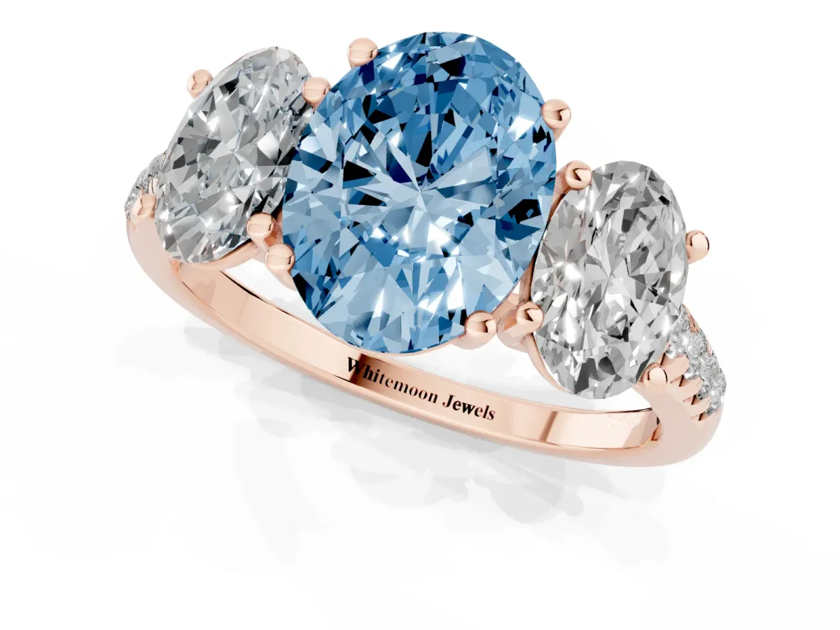 Fancy Blue Three-Stone Oval Cut Diamond Ring with Round Pavé Band and Prong Setting Rose gold