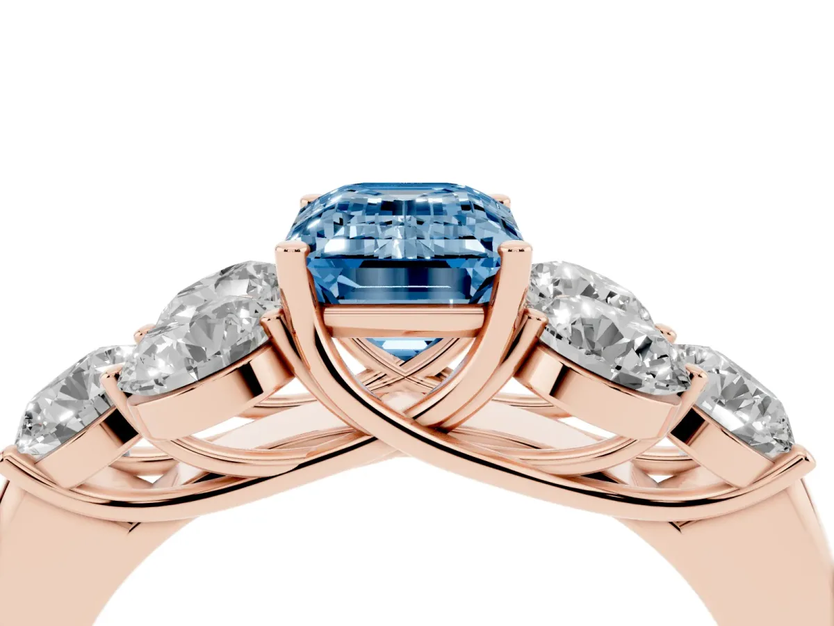 Fancy Blue Emerald Cut Cut Diamond Cluster Ring with Round Accent Stones and Prong Setting on a Classic Band Rose gold
