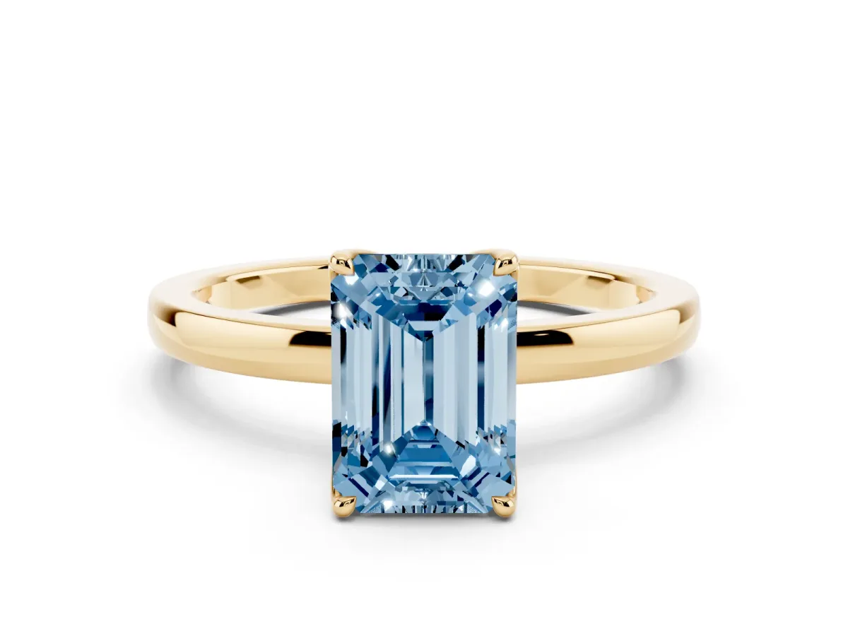 Fancy Blue Emerald Cut Diamond Solitaire Ring with Thin Band and Prong Setting Yellow gold