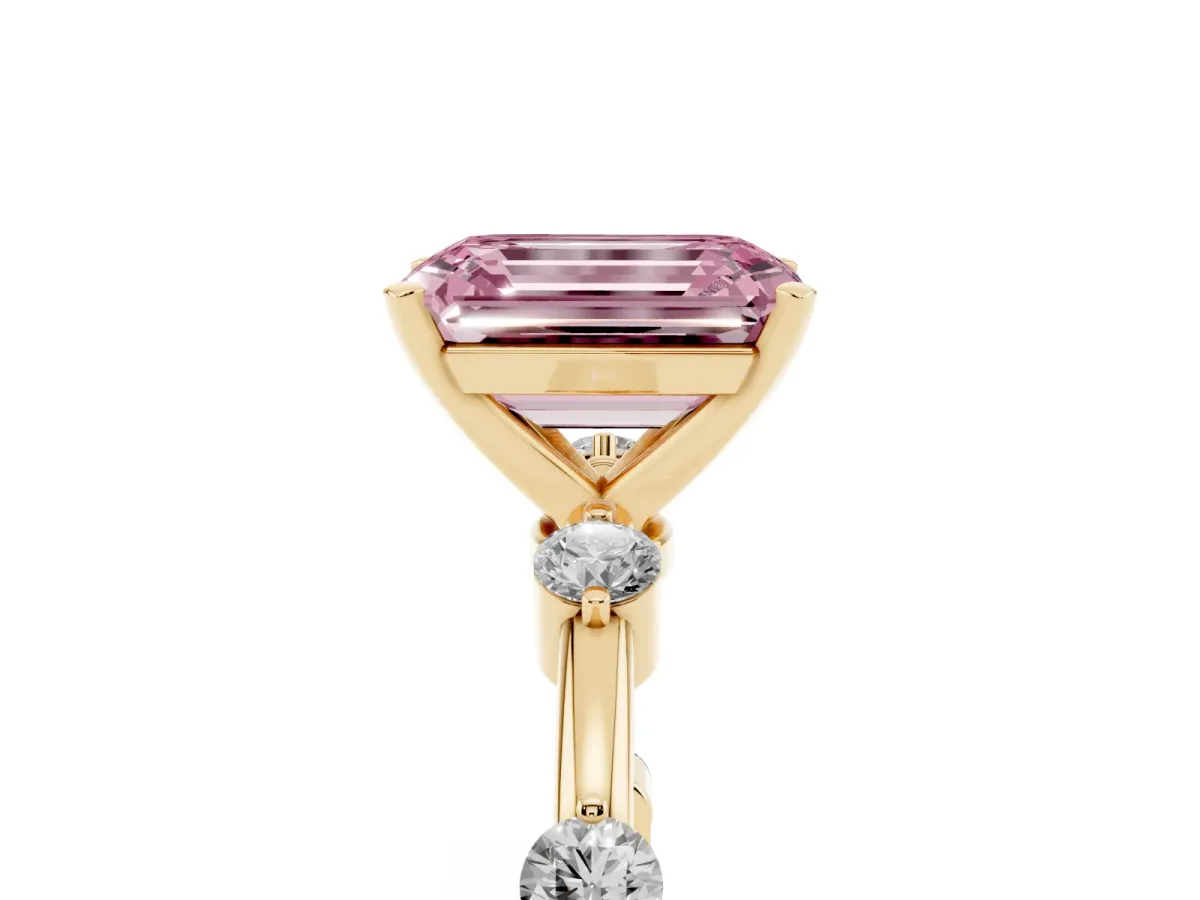 Fancy Pink Emerald Cut Solitaire Diamond Ring with Bezel Set Side Stones and Prong Setting Yellow gold