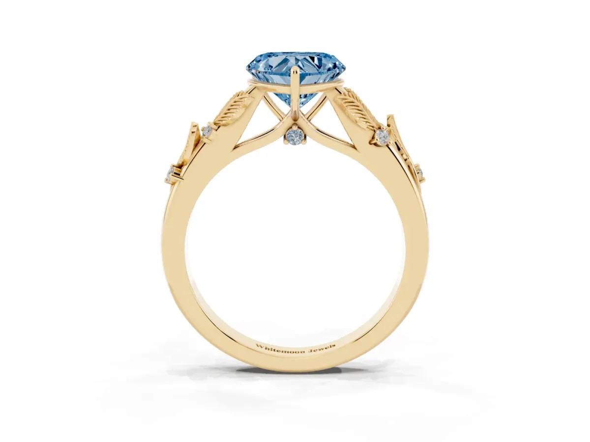Fancy Blue Heart Cut Diamond Solitaire Ring with Leaf Motif Band and Four-Prong Setting Yellow gold