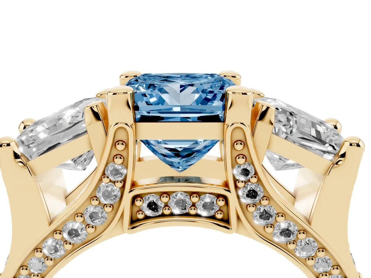Fancy Blue Princess Cut Diamond Three-Stone Ring with Channel Set Band and Four-Prong Setting Yellow gold