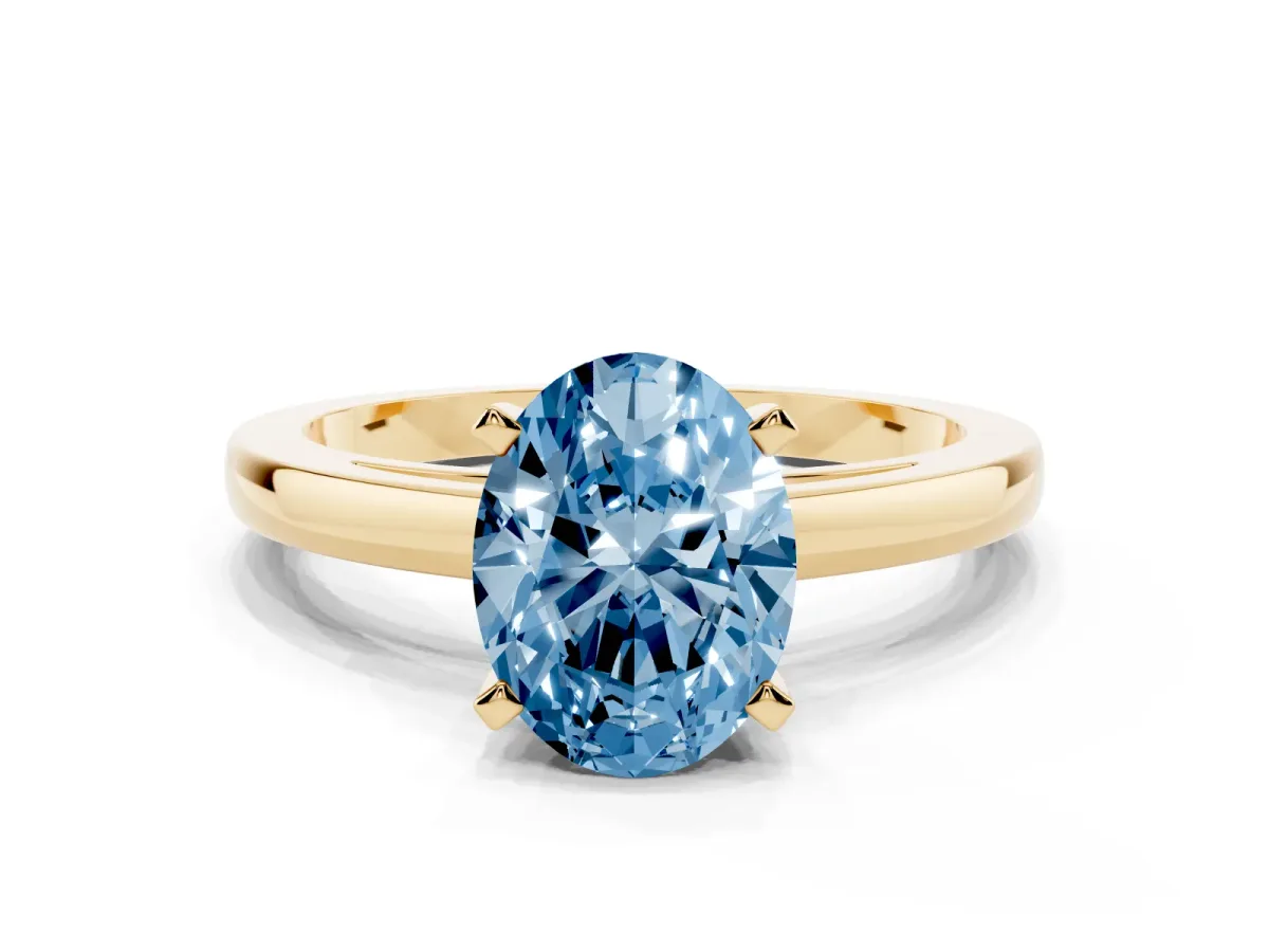 Fancy Blue Oval Cut Solitaire Diamond Engagement Ring with Four-Prong Setting on a Classic Band Yellow gold