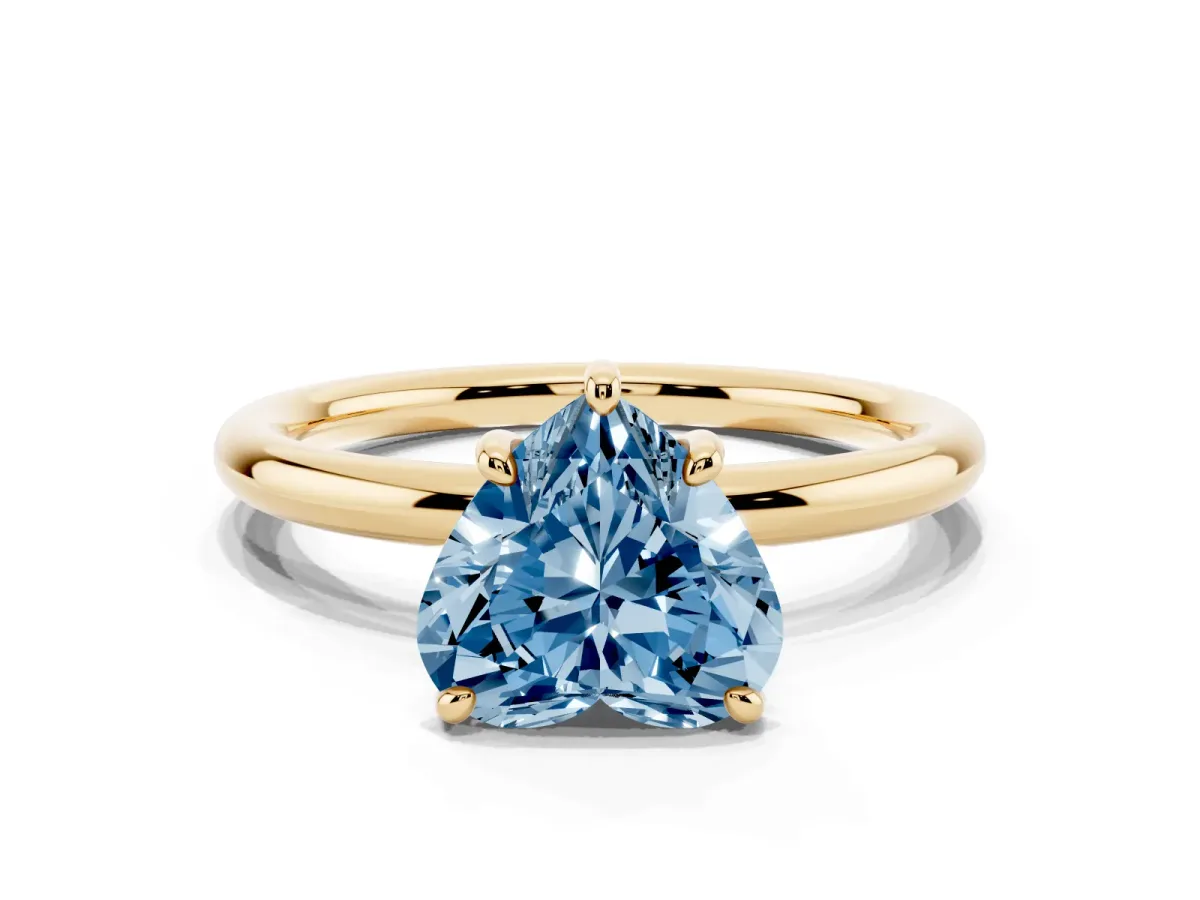 Fancy Blue Heart Cut Solitaire Diamond Ring with Four-Prong Setting on a Plain Band Yellow gold