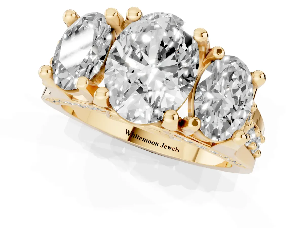 Oval Cut Diamond Three-Stone Ring with Channel Set Band and Four-Prong Setting Yellow gold