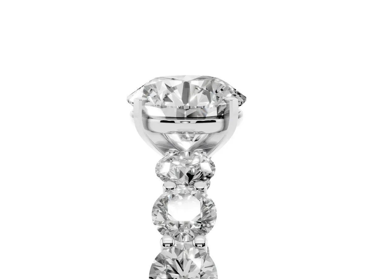 Round Cut Diamond Prong Setting with Side Stones on a Pave Band Silver