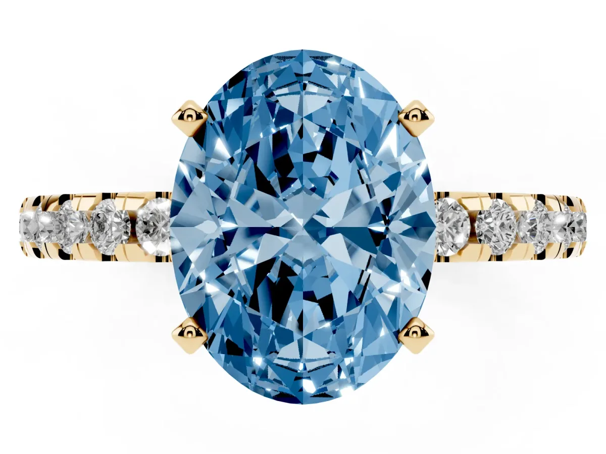 Fancy Blue Oval Cut Diamond Solitaire Ring with Round Pavé Band and Four-Prong Setting Yellow gold