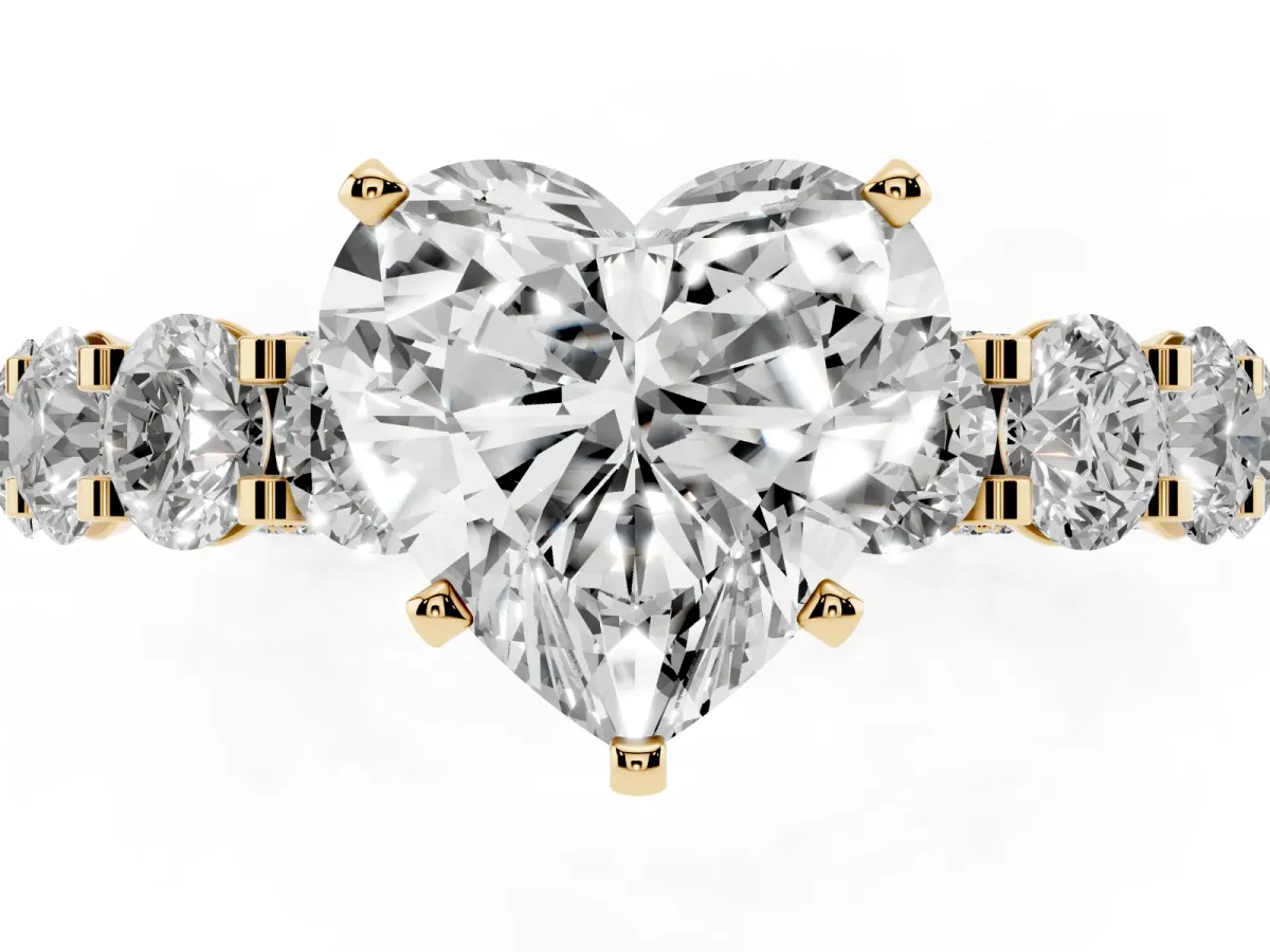 Heart Cut Diamond Side Stone Engagement Ring with Four-Prong Setting Yellow gold