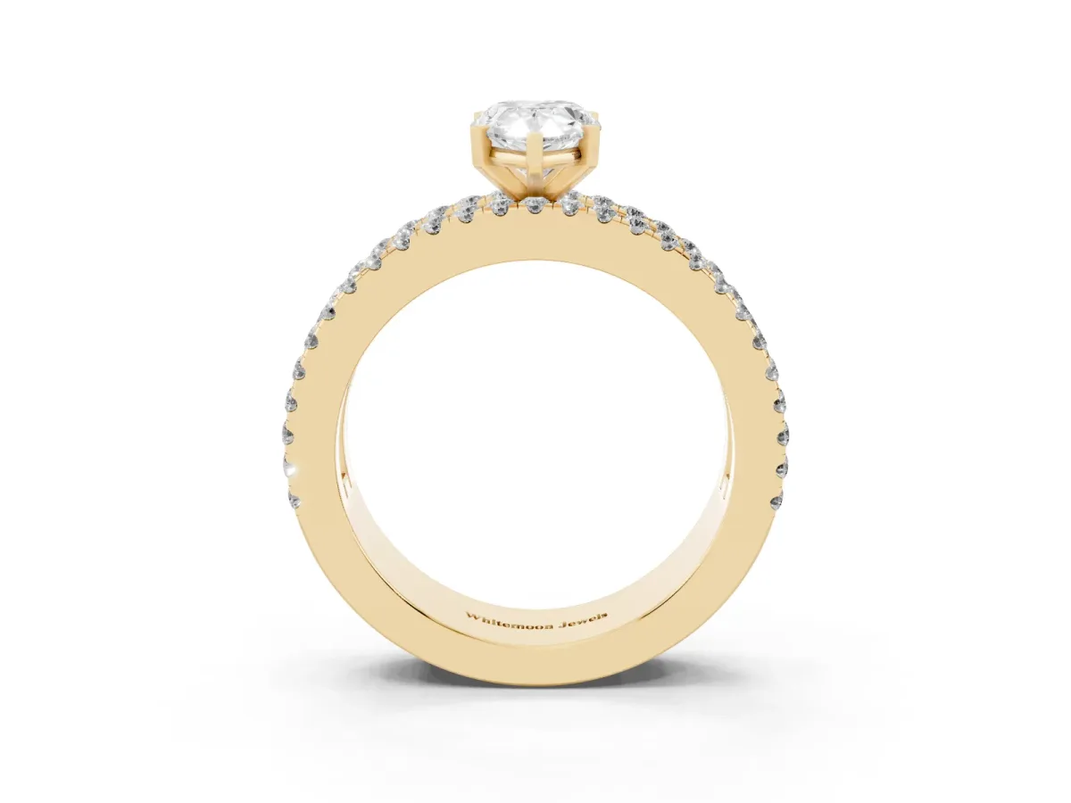 Pear Cut Diamond Solitaire Ring with Pavé and Channel Set Band Yellow gold