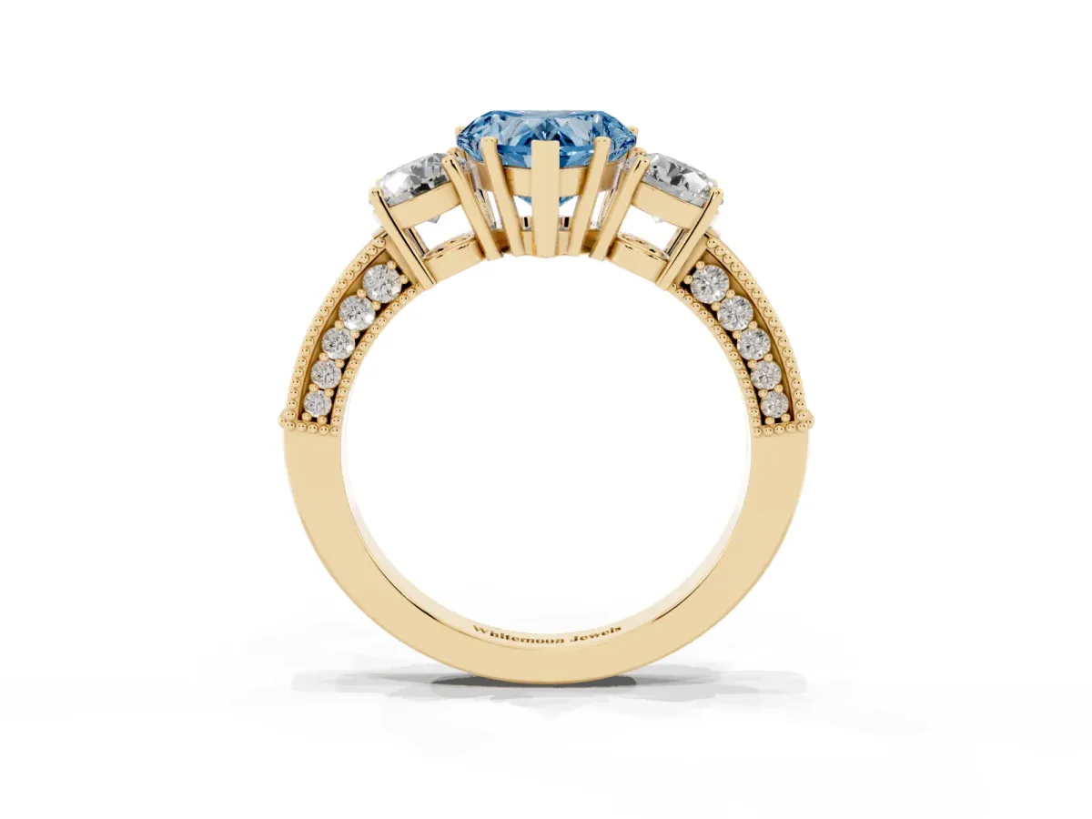 Fancy Blue Heart Cut Three-Stone Diamond Ring with Pavé Band and Four-Prong Setting Yellow gold