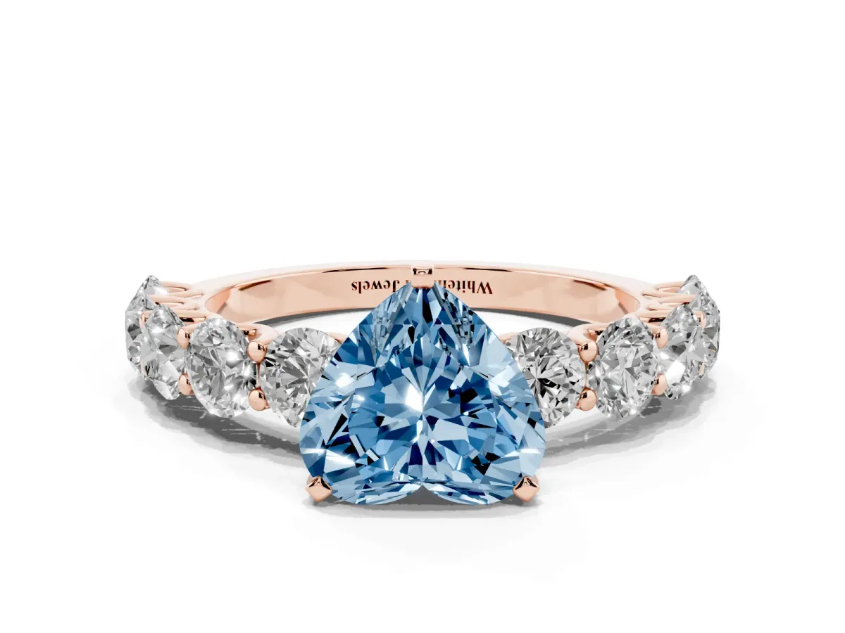 Fancy Blue Heart Cut Diamond Prong Setting with Side Stones on a Pave Band Rose gold
