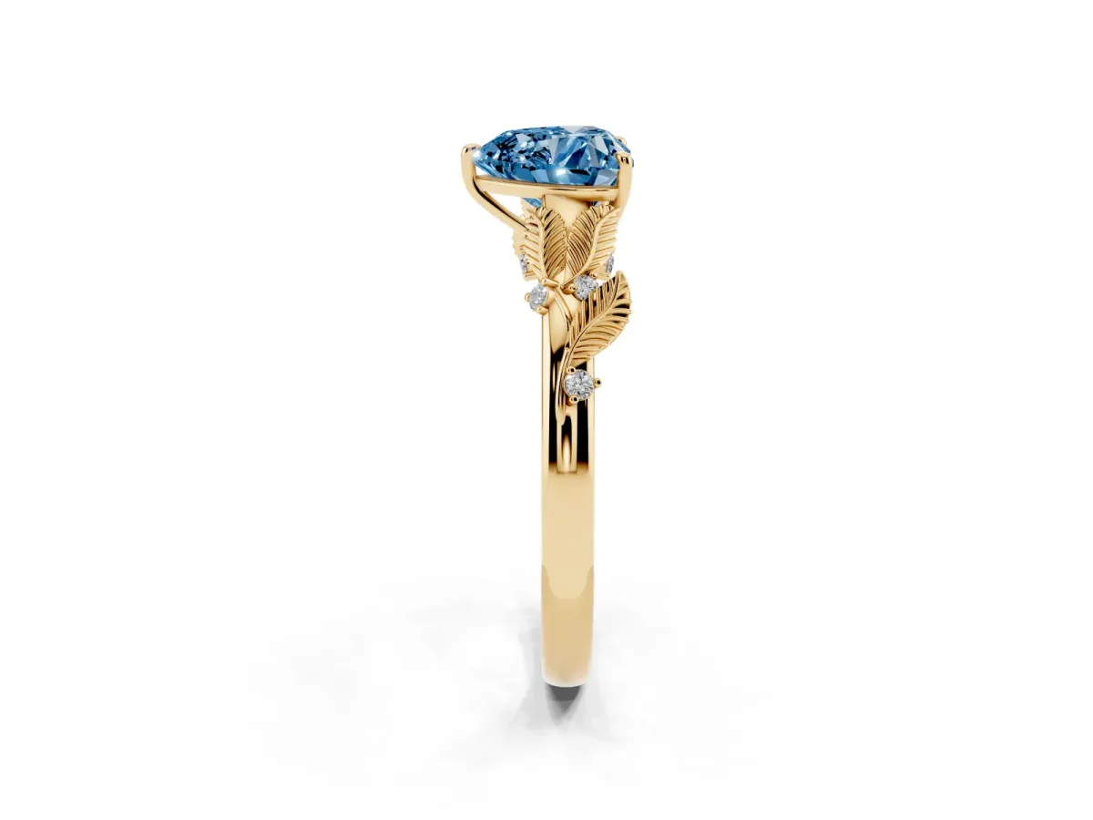 Fancy Blue Heart Cut Diamond Solitaire Ring with Leaf Motif Band and Four-Prong Setting Yellow gold