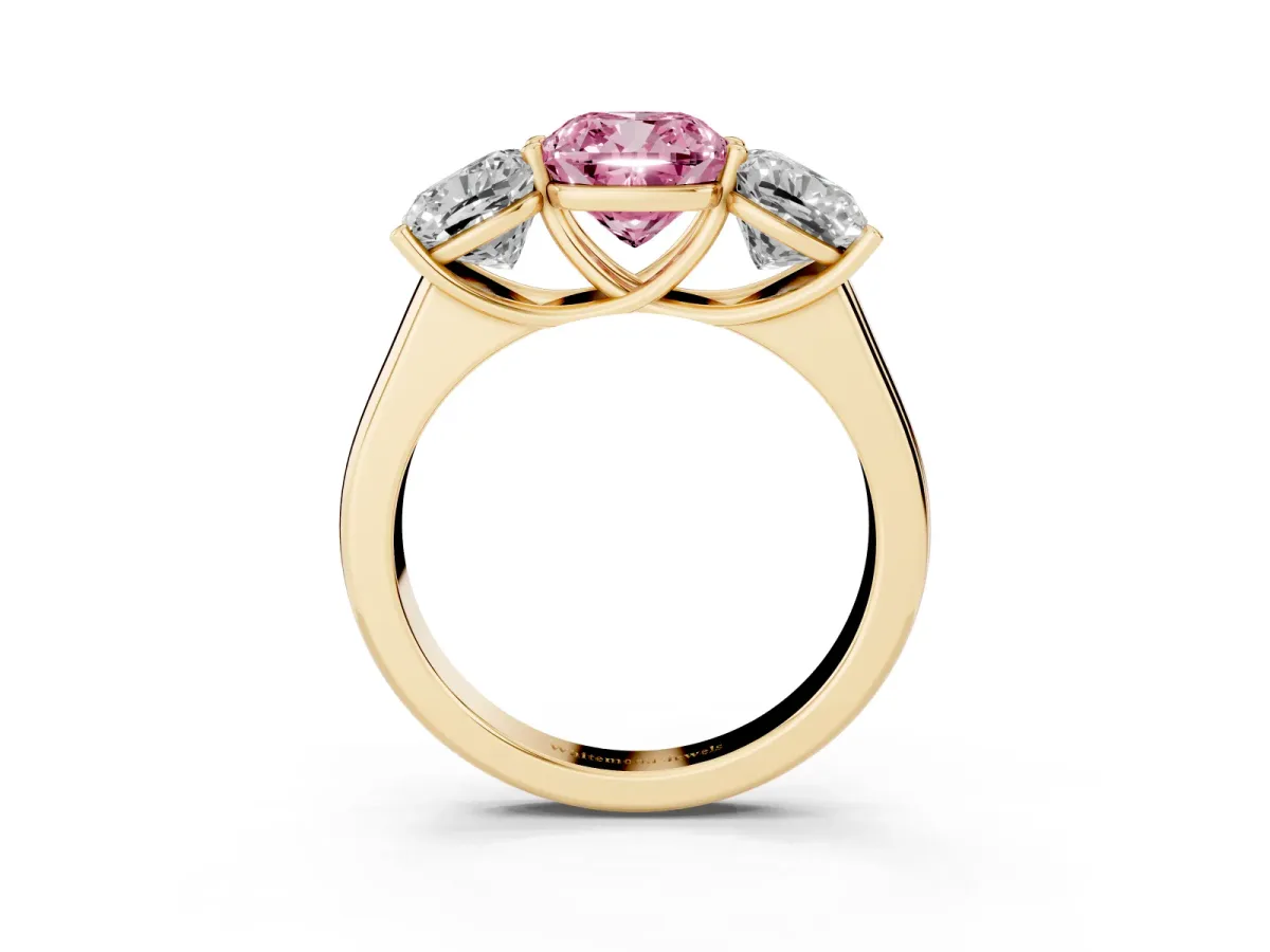Fancy Pink Cushion Cut Three-Stone Diamond Ring with Prong Setting on a Classic Band Yellow gold