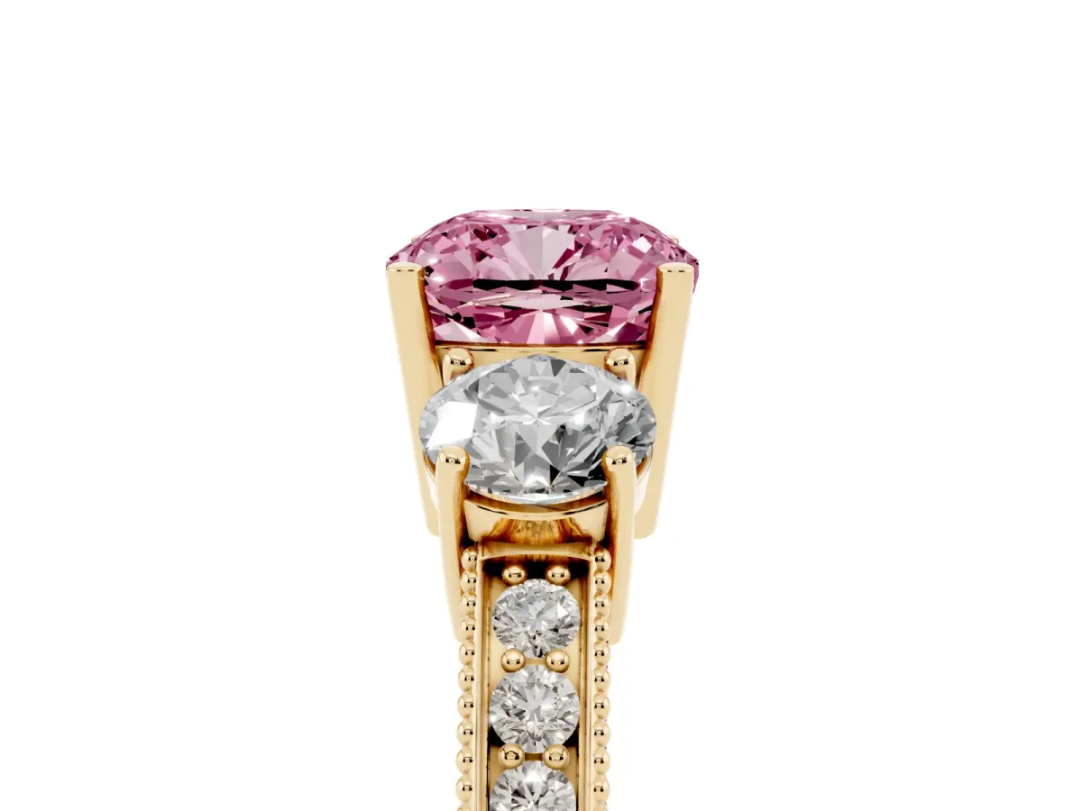 Fancy Pink Cushion Cut Three-Stone Diamond Ring with Pavé Band and Four-Prong Setting Yellow gold