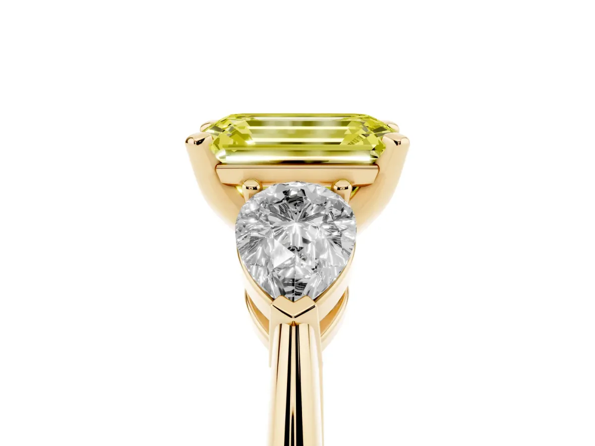 Fancy Yellow Three-Stone Emerald Cut Diamond Ring with Pear Side Stones and Four-Prong Setting Yellow gold