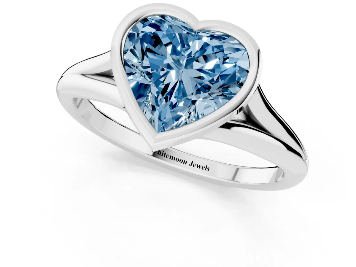 Fancy Blue Bezel Set Heart Cut Cut Solitaire Ring with Tapered Band White gold
