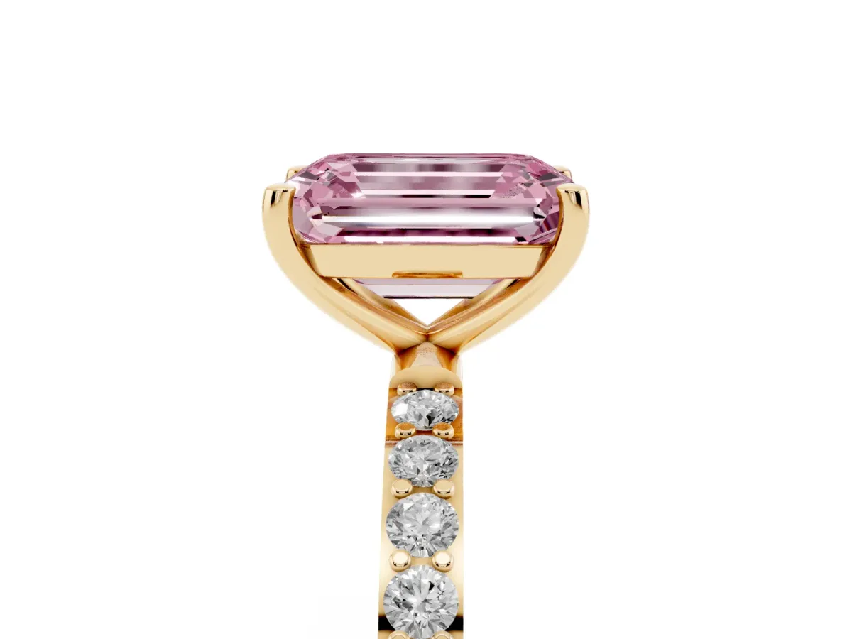 Fancy Pink Emerald Cut Diamond Solitaire Ring with Round Pavé Shoulders and Prong Setting Yellow gold