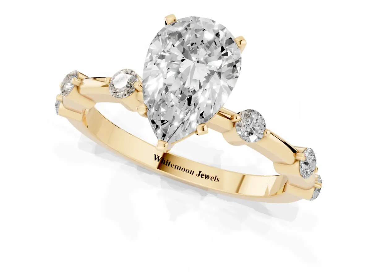 Pear Cut Solitaire Diamond Ring with Bezel Set Side Stones and Prong Setting Yellow gold