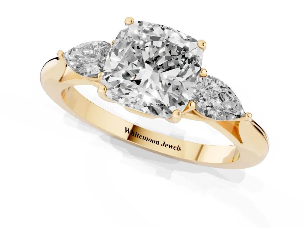 Cushion Cut Diamond Three-Stone Ring with Pear Side Stones and Prong Setting Yellow gold