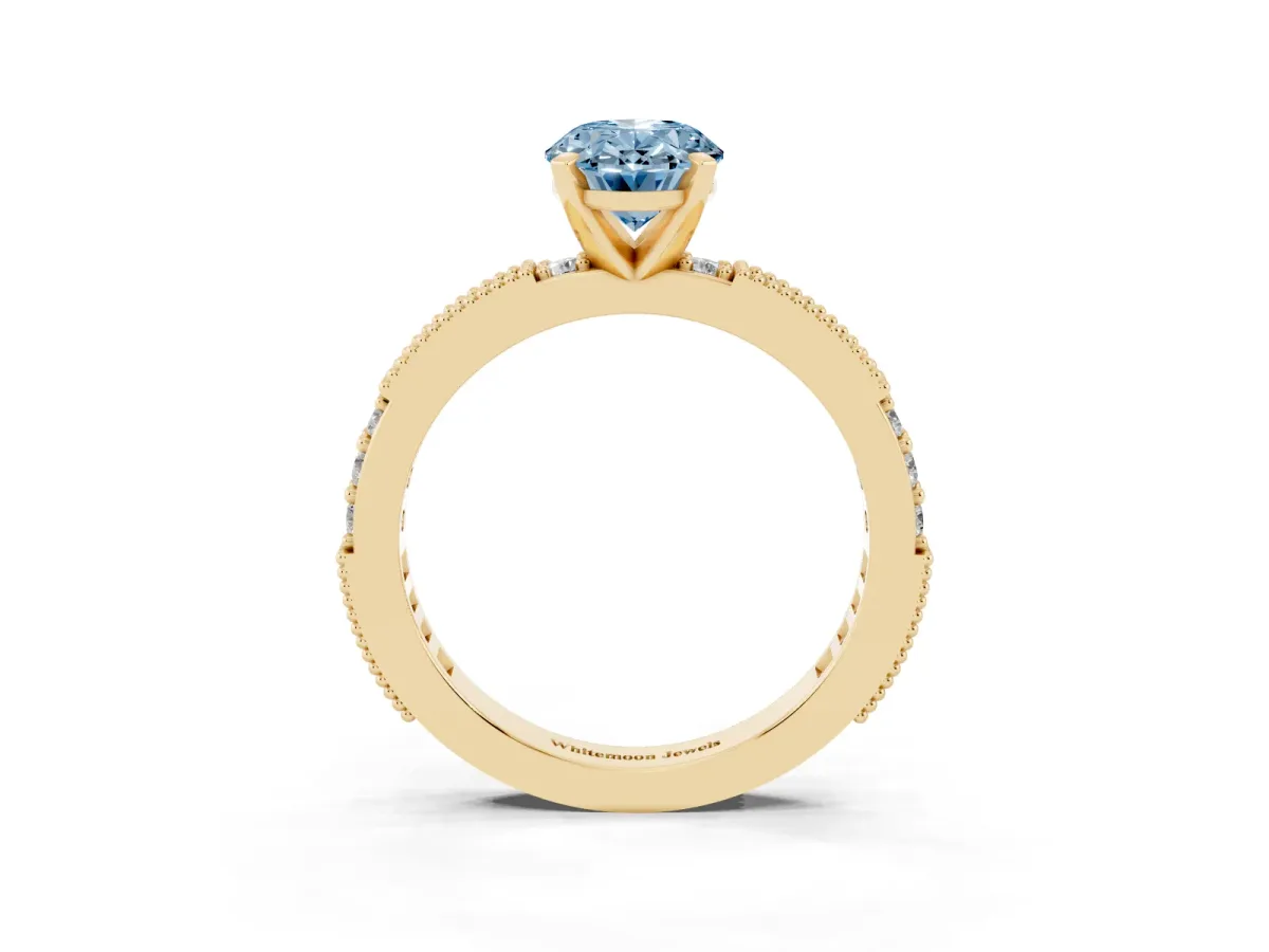 Fancy Blue Oval Cut Solitaire with Pavé Band and Four-Prong Setting Yellow gold