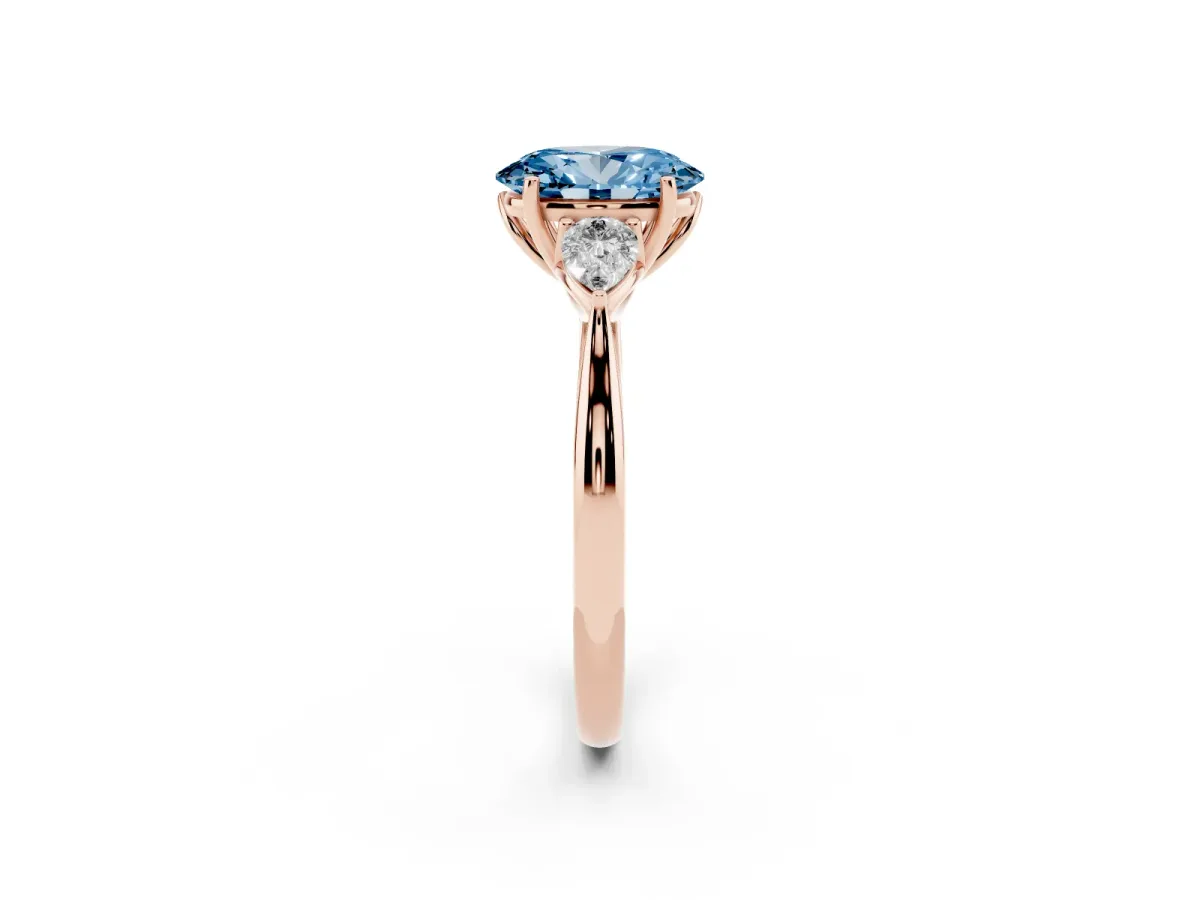 Fancy Blue Three-Stone Oval Cut Diamond Ring with Pear Side Stones in Four-Prong Setting Rose gold