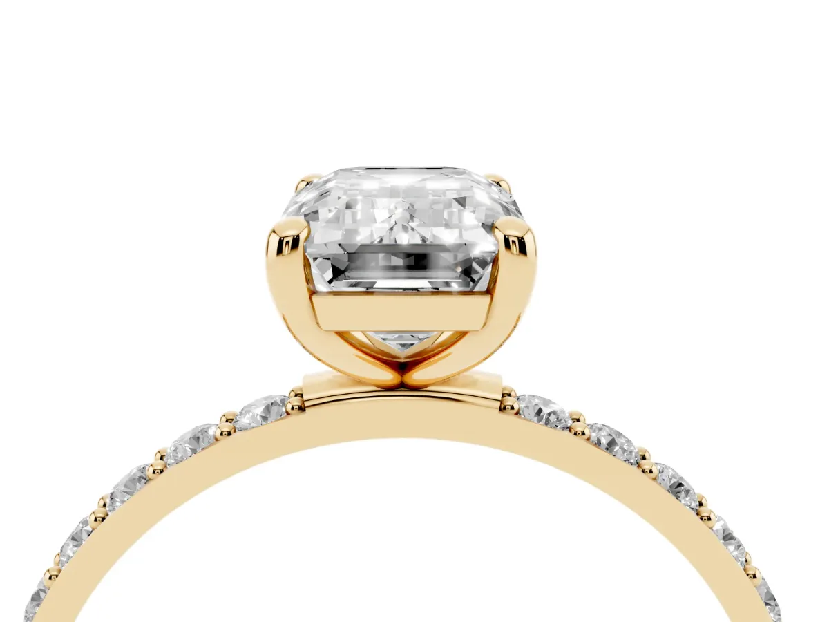 Emerald Cut Diamond Solitaire Ring with Round Pavé Band and Prong Setting Yellow gold