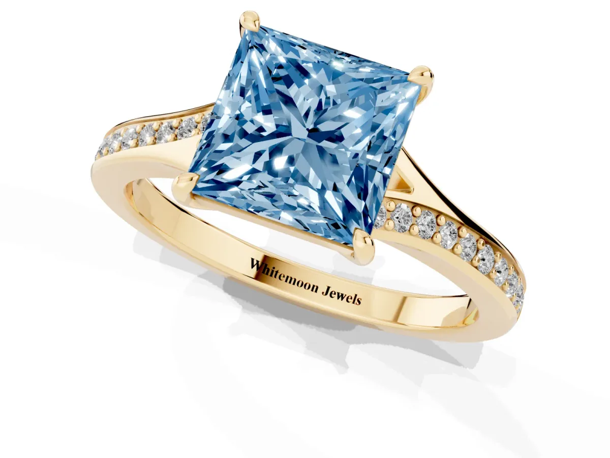 Fancy Blue Princess Cut Diamond Solitaire Ring with Pavé Band and Prong Setting Yellow gold