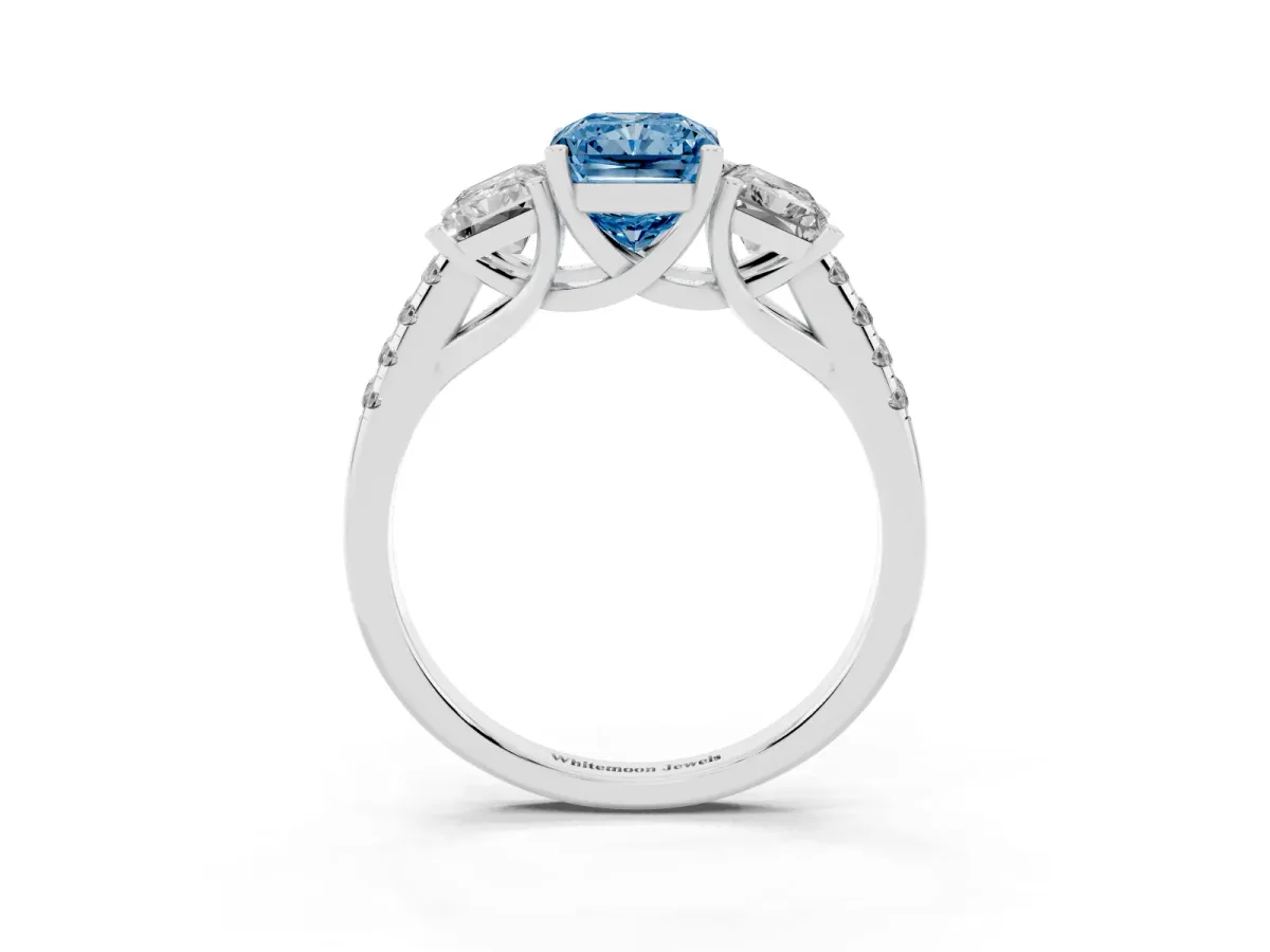 Fancy Blue Three-Stone Radiant Cut Diamond Ring with Round Pavé Band and Prong Setting Silver