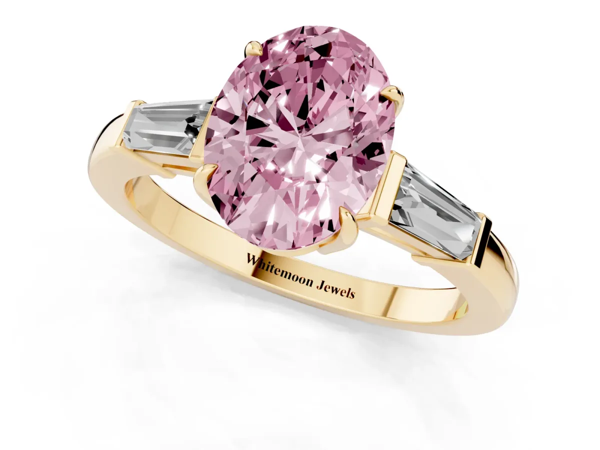Fancy Pink Oval Cut Diamond Three-Stone Ring with Tapered Baguette Side Stones and Prong Setting Yellow gold