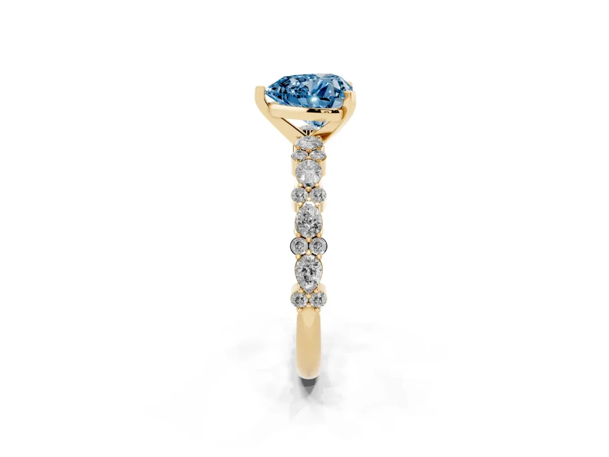 Fancy Blue Heart Cut Diamond Side Stone Solitaire Ring with Round and Four-Prong Setting Yellow gold