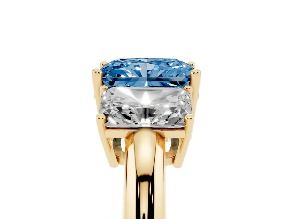Fancy Blue Three-Stone Radiant Cut Cut Diamond Engagement Ring with Prong Setting on a White Gold Band Yellow gold