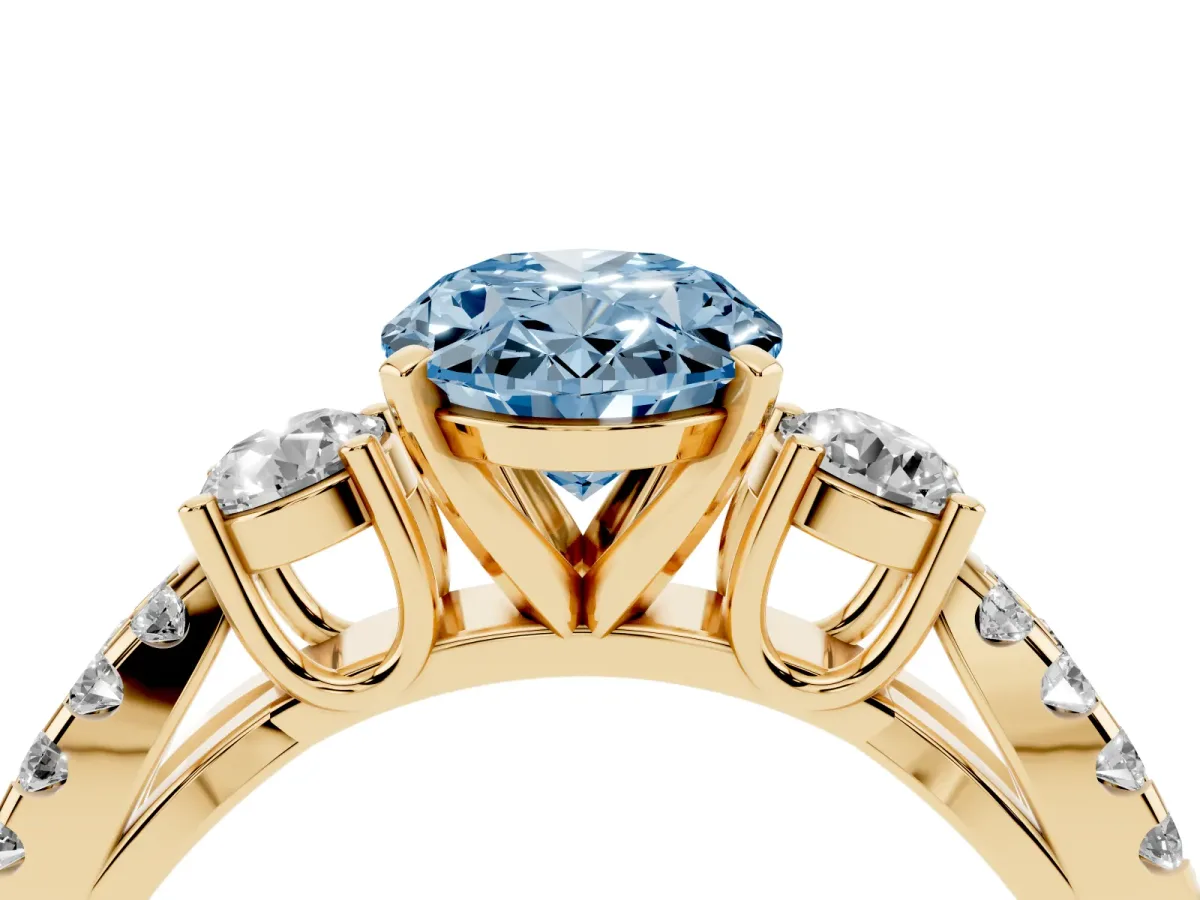 Fancy Blue Oval Cut Diamond Three-Stone Ring with Pavé Split Shank and Four-Prong Setting Yellow gold