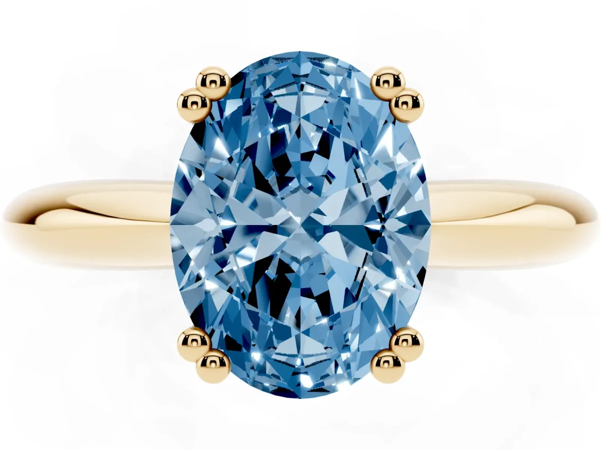 Fancy Blue Oval Cut Cut Solitaire Engagement Ring with Tapered Band and Four-Prong Setting Yellow gold
