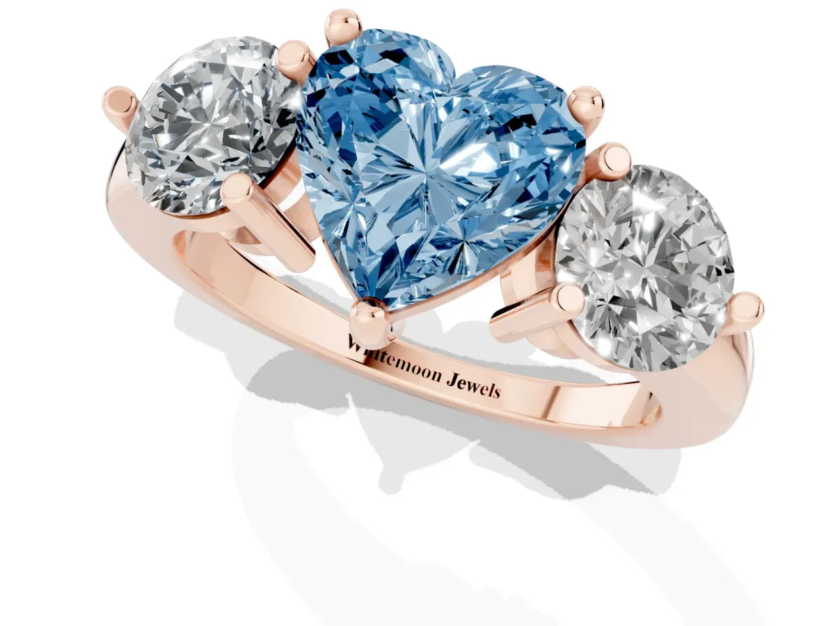 Fancy Blue Three-Stone Heart Cut Brilliant Cut Solitaire Ring with Prong Setting on a Classic Band Rose gold