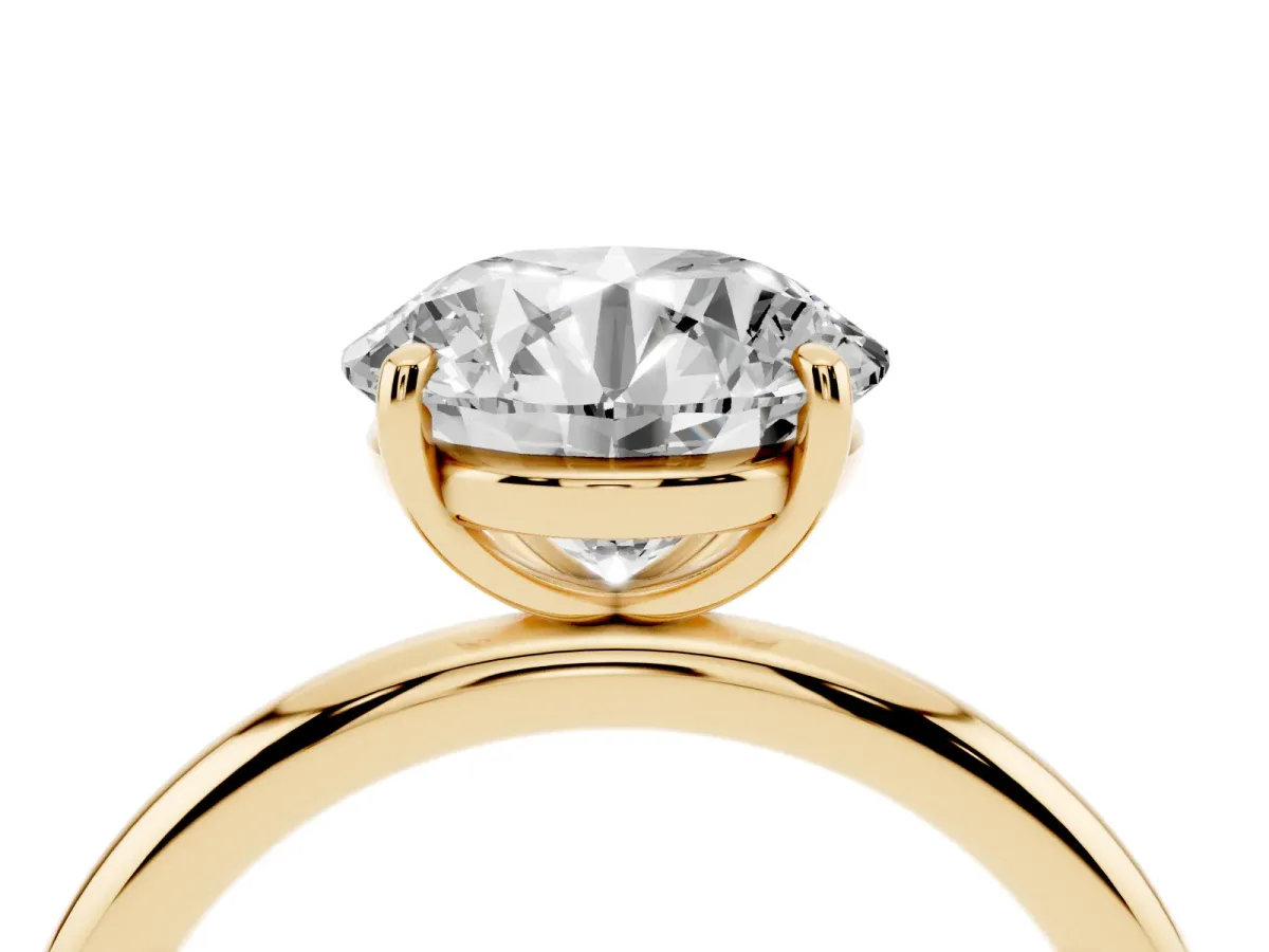Round Cut Solitaire Diamond Ring with Four-Prong Setting on a Plain Band Yellow gold