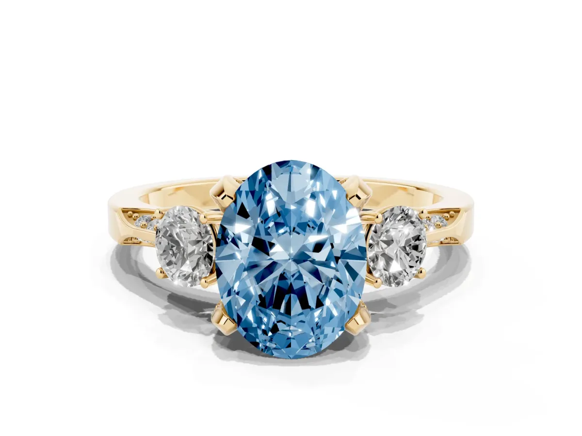 Fancy Blue Oval Cut Brilliant Three-Stone Diamond Ring with Pavé Band and Four-Prong Setting Yellow gold