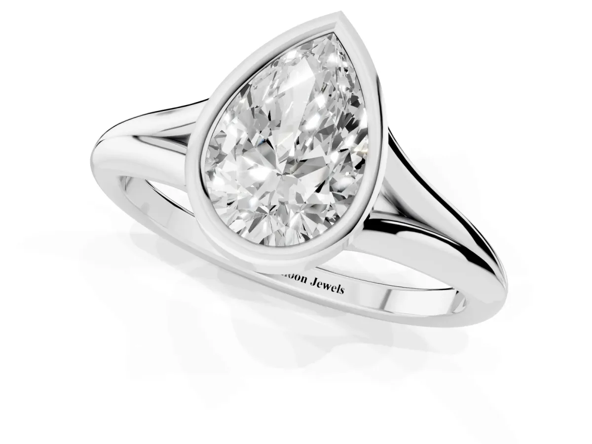 Bezel Set Pear Cut Cut Solitaire Ring with Tapered Band Platinum