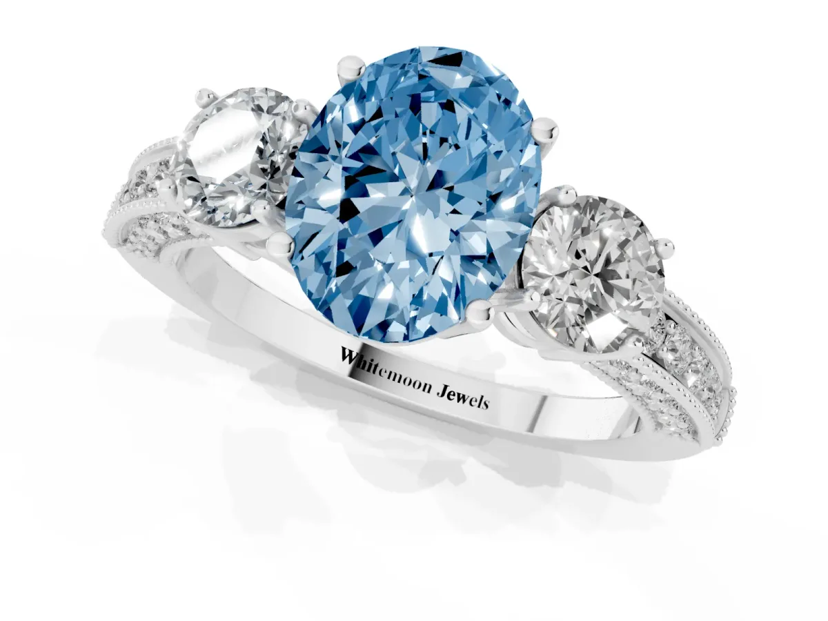 Fancy Blue Oval Cut Three-Stone Diamond Ring with Pavé Band and Four-Prong Setting Platinum