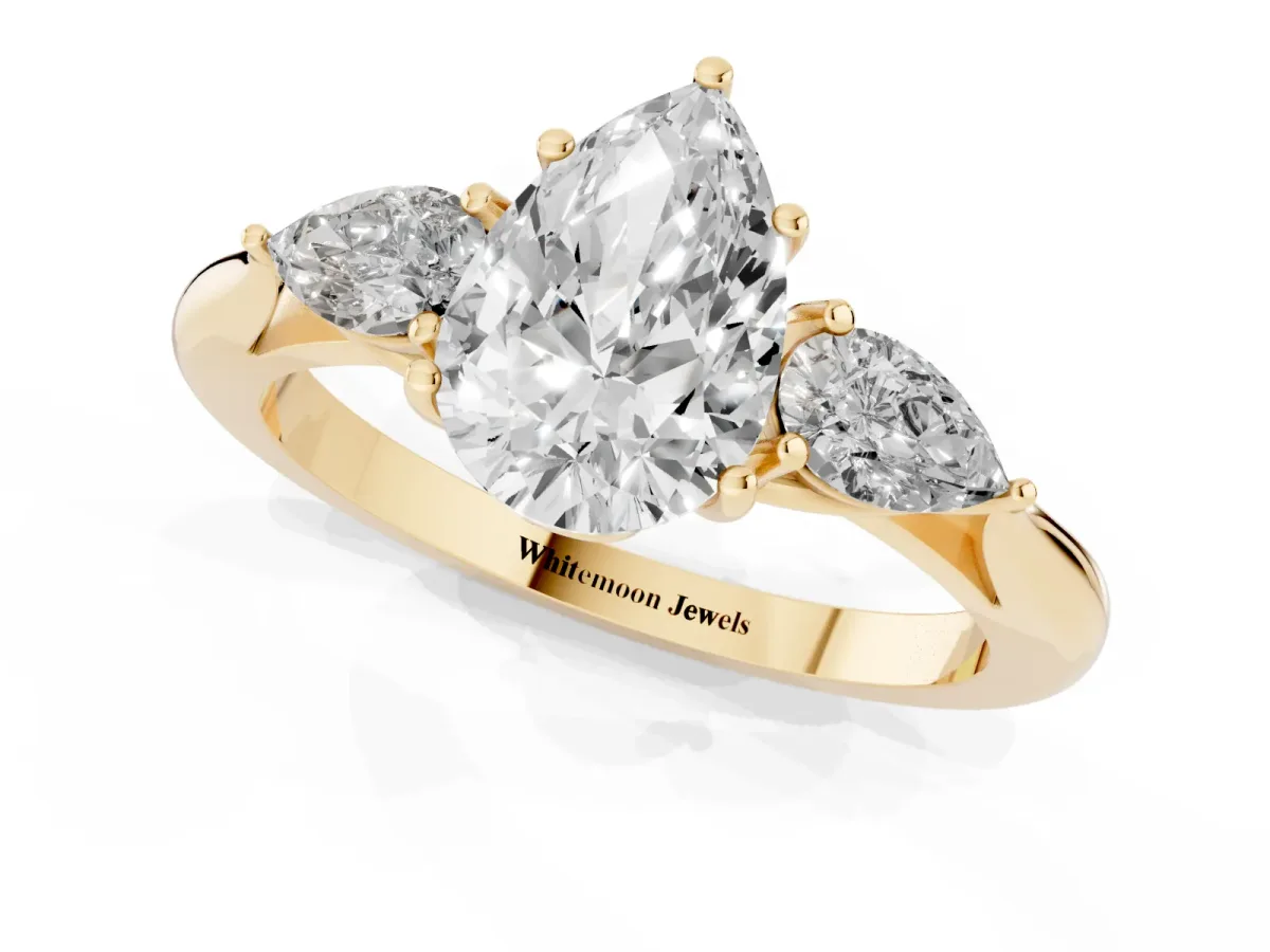 Three-Stone Pear Cut Diamond Ring with Pear Side Stones in Four-Prong Setting Yellow gold