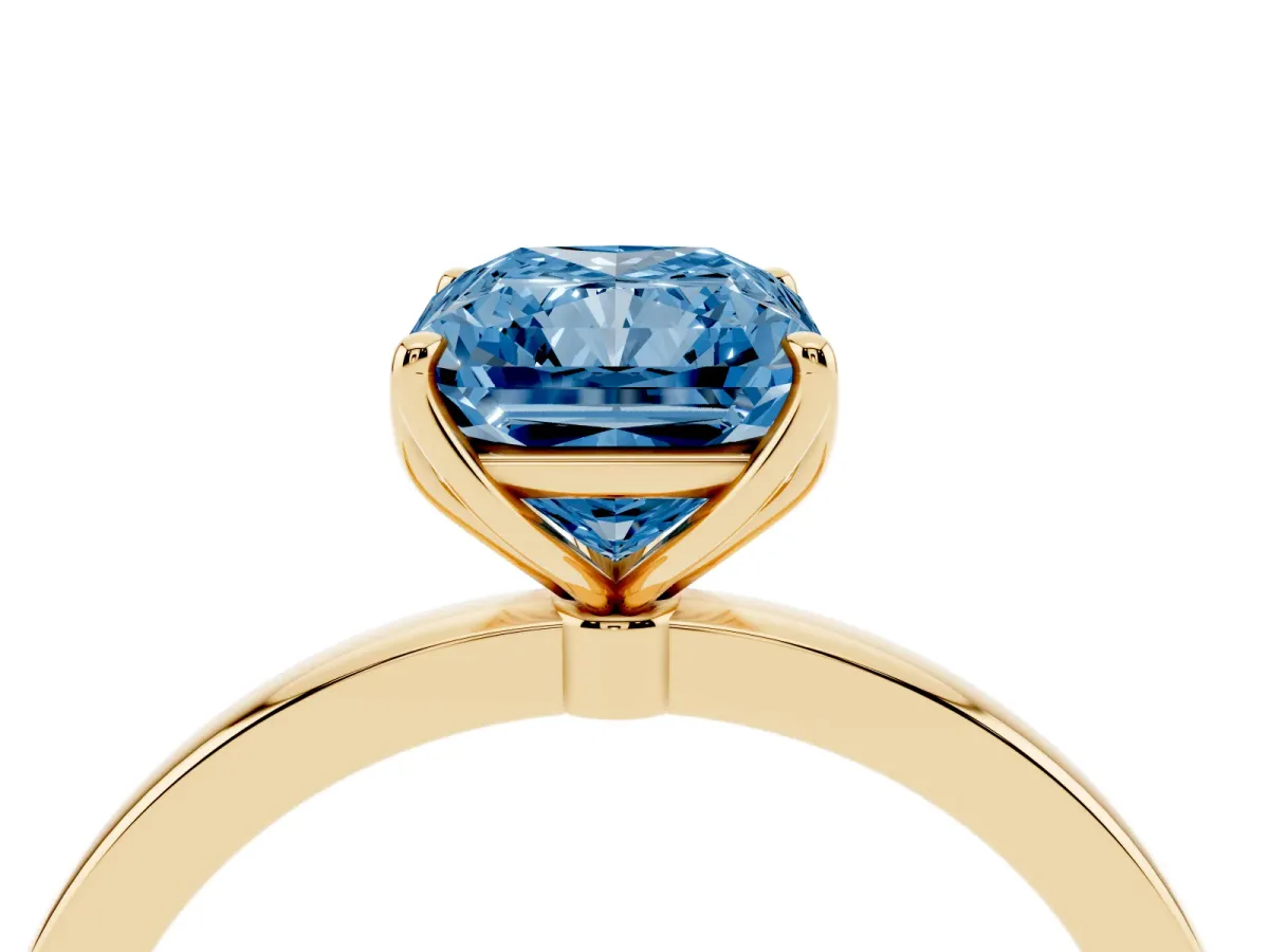 Fancy Blue Radiant Cut Diamond Solitaire Ring with Thin Band and Prong Setting Yellow gold