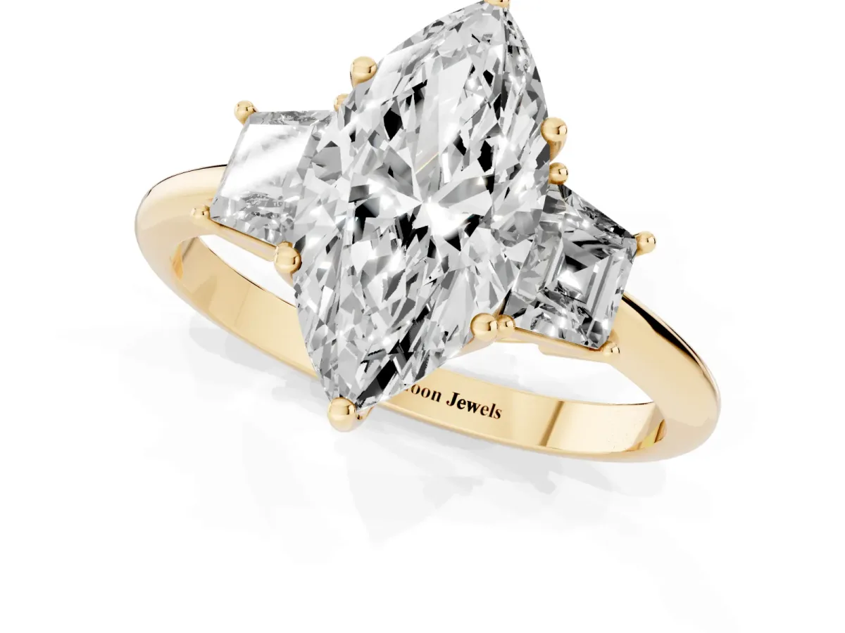 Marquise Cut Diamond Three-Stone Ring with Trapezoid Side Stones and Prong Setting Yellow gold