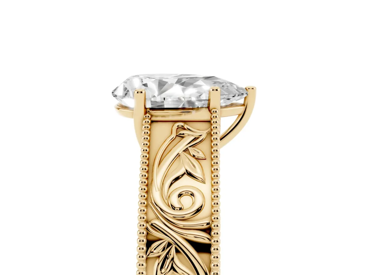 Pear Cut Diamond Solitaire Ring with Engraved Band and Four-Prong Setting Yellow gold